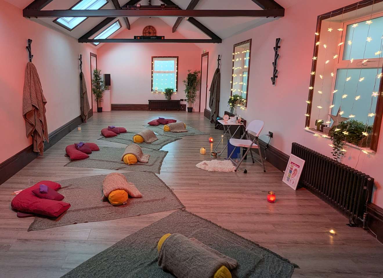 A calm group session room at The Rookery with blankets, cushions and soft lighting.